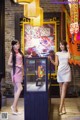 Two women standing next to each other in front of a display case.